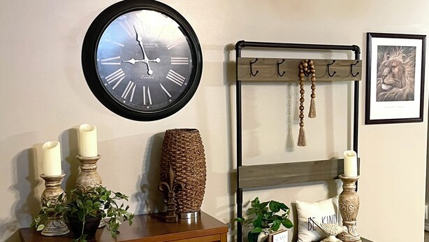 A wooden cabinet with two candles and a plant, a wall clock, a shelf with a sign, and a framed picture. - Enjoy a cozy holiday getaway in our peaceful rural home.
WIFI NOT AVAILABLE (Mead)