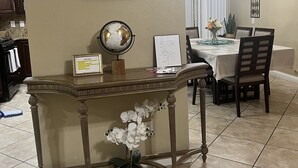 A dining area with a table set for four, a globe, a framed quote on the wall, and a decorative plant. - Nice 3 bedroom's house owner occ and 2 bathroom with fast WI-Fi,  Full Kitchen (Las Vegas)
