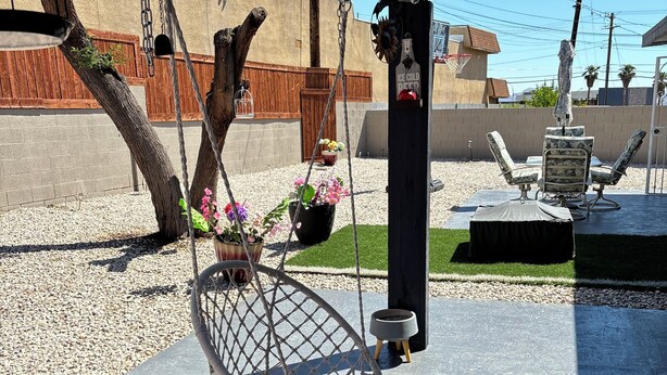 A hanging chair with a cushion, a small table with a bowl, and a hanging light fixture. - Nice 3 bedroom's house owner occ and 2 bathroom with fast WI-Fi,  Full Kitchen (Las Vegas)