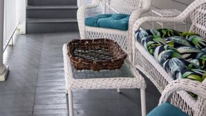A covered porch with wicker furniture, a staircase, and a potted plant. - M1 at Saint Philip Square, One Block to King, Cozy Bright Stay (Charleston)