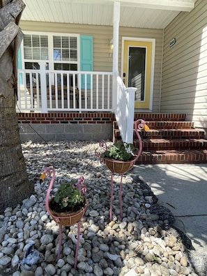 Welcome to this charming single-family home with a cozy porch and inviting entrance.