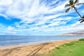 Enjoy a serene beach experience with gentle waves lapping at the shore.