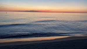 A beach at sunset with calm water and a clear sky. - South Haven Condo w/ LAKE MICHIGAN + LIGHTHOUSE VIEWS w/ POOL + PRIVATE BEACH  (South Haven)