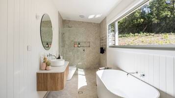 Bathtub, eco-friendly toiletries, hair dryer, towels