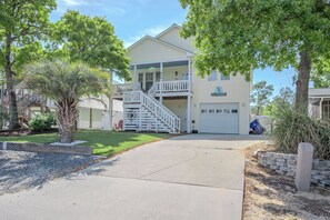 A two-story house with a front porch, a staircase leading to the second floor, and a garage.