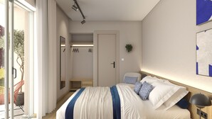 Ein modernes Schlafzimmer mit einem Bett, einem Kleiderschrank und einer Tür, die auf einen Balkon führt.
