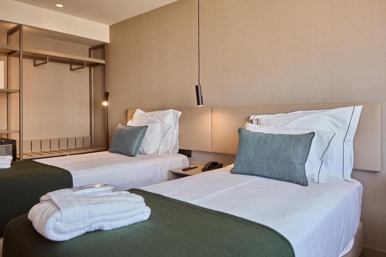 omid twin | premium bedding, memory-foam beds, minibar, in-room safe