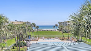 A resort with a pool, lounge chairs, and a view of the beach. - Gorgeous 3 bedroom 2 bath unit. Beachfront property! (Destin)