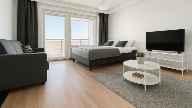 Habitación de hotel moderna con cama, sofá, televisor y vista a la playa.