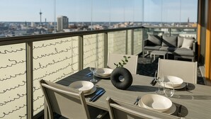 Un comedor con una mesa dispuesta para dos personas, con vistas a la ciudad.