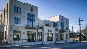 A modern building with a storefront labeled "BOX" and a sign for "KIRKWOOD."