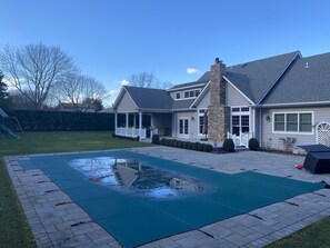 Relax in a serene outdoor space with a swimming pool and enjoy leisure activities in the spacious backyard.