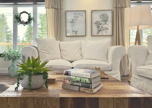 Relax in this serene space with a sofa, armchair, and potted plant, perfect for reading and playing chess.