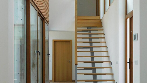 A modern interior with a wooden staircase, a glass door, and a tiled floor. - Brand New Villa with Private Pool and Lovely Garden near the beach.
 (Alvor)