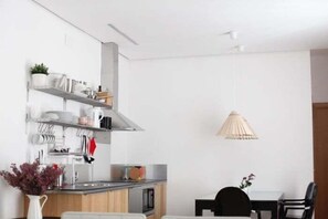 A modern kitchen with a dining area, including a table and chairs.