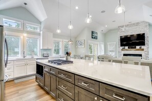 Enjoy cooking in this well-equipped kitchen with a large island, oven, and spacious seating area.