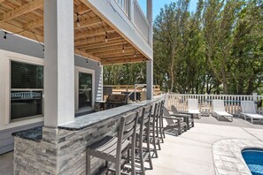 Relax in the serene outdoor patio, complete with a grill and comfortable seating.
