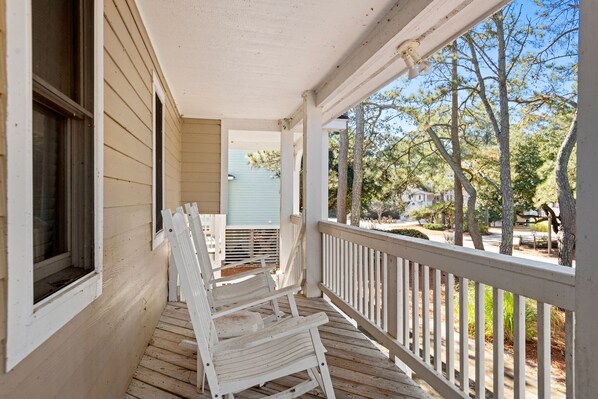 A wooden porch with white railings and a bench. - Endless Sunsets in Corolla Light: Pool, Spa, Club Amenities & Golf Discounts! (Corolla)