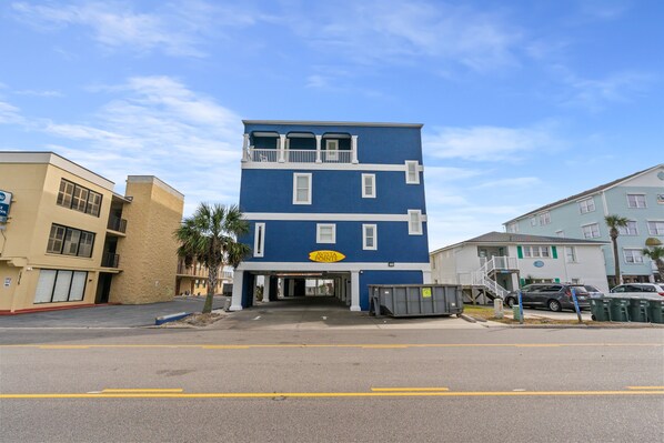 A two-story building with a blue facade and a yellow sign reading "AVISTA POINT."