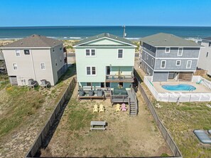 A beachfront property with a pool, outdoor seating, and a view of the ocean. - Surf's Up: Semi-Oceanfront, Hot Tub, Awesome Views (Kitty Hawk)