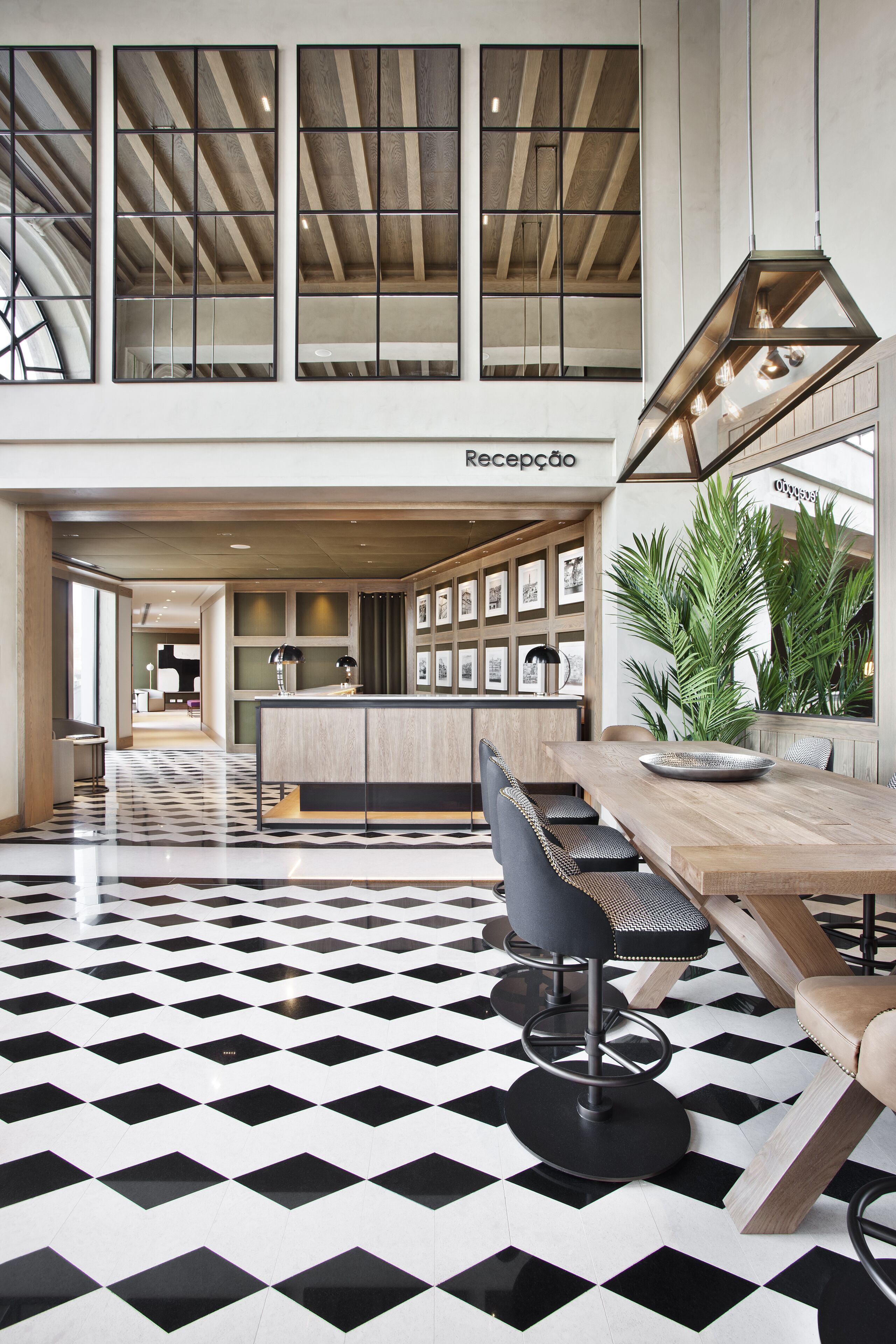 A modern reception area with a checkered floor, a wooden reception desk, and a seating area with a bar stool.