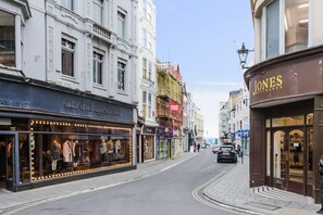 A street view with shops, including a visible storefront with mannequins and a sign that reads "JONES SOOTMAKER". - City Heart Brighton (Brighton)