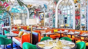 A vibrant restaurant interior with colorful seating, large windows, and artistic wall decorations. - City Heart Brighton (Brighton)