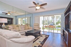 Appart'hôtel, plusieurs lits, piscine privée, vue jardin | Salle de séjour | Télévision