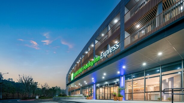 A Holiday Inn Express hotel with a modern design, featuring a prominent entrance and a well-lit facade. - Holiday Inn Express Nanjing Happy Valley by IHG (Nanjing)