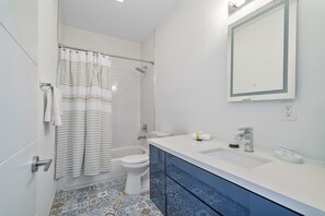 Bathtub, hair dryer, towels, soap
