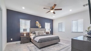 A bedroom with a bed, nightstands, a ceiling fan, and a window with blinds. - New Townhome near Wilton Manors/Las Olas (Fort Lauderdale)