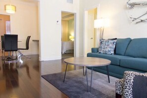 Relax in this stylish living room with a comfortable sofa, a chic chair, and a coffee table.