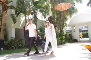 Relax under a shaded area surrounded by lush greenery and tropical plants.