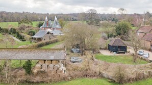 A rural landscape with a large barn, a smaller house, and a church with a steeple. - The Granary by Bloom Stays - cute lodge sleeps 2 guests  in 1 bedroom (Canterbury)