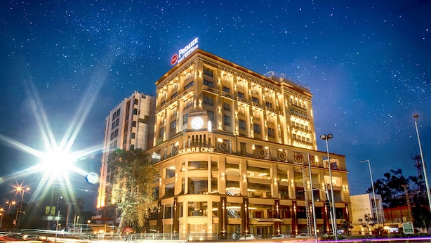 A multi-story hotel with illuminated signage, including "Premier Hotel West" and "Square One" on the facade. - Best Western Premier Hotel Gulberg Lahore (Lahore)