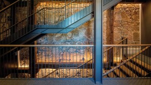 A multi-level staircase with metal railings and stone walls. - Sofraga Palacio (Ávila)