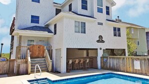 A two-story building with a pool and bar area. - Dreamcatcher is a well-equipped vacation home perfect for a terrific vacation experience. (Corolla)
