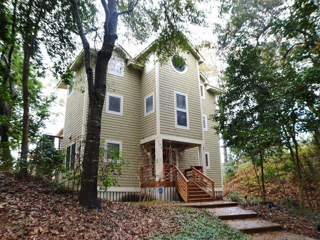 This soundfront haven is nestled into a cliff among the pines & live oaks overlooking the sound. 