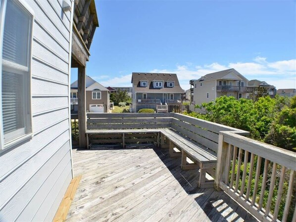 Enjoy a peaceful seating area on the deck with a curved bench and railing.