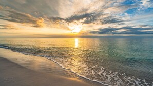 A beach with a sunset over the ocean. - Stella Marris- N. Captiva Island | Luxury Beachfront Retreat (Lee County)