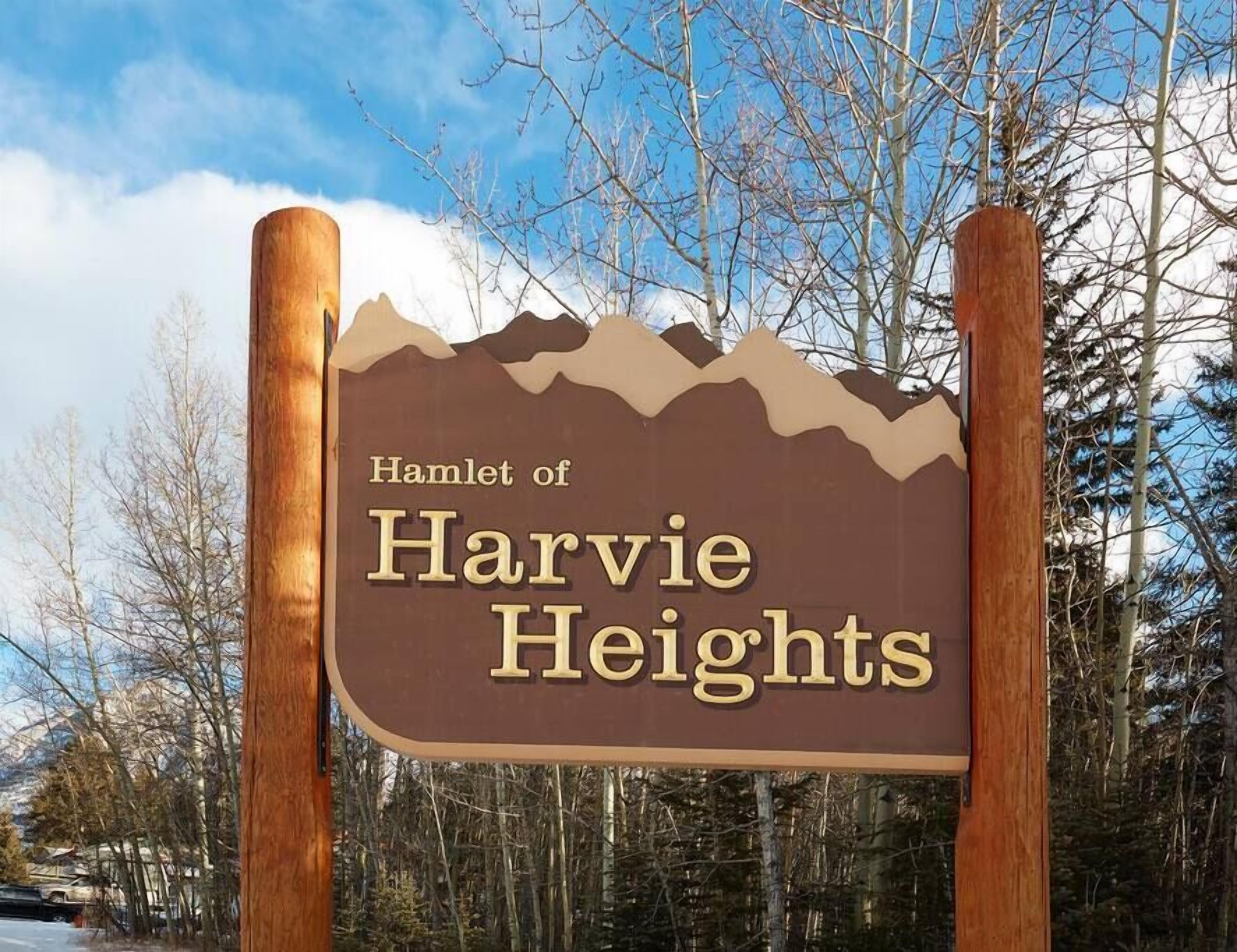 A sign for Harvie Heights with a mountainous design.