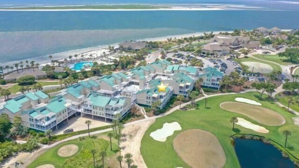 An aerial view of a resort with multiple buildings, a swimming pool, and a golf course. - 2BR/2BA Gorgeous Views! Steps to Beach,Pool,Club House & Restaurants! Amenity access included (Seabrook Island)