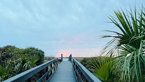 A wooden boardwalk leading to a beach with a sunset in the background. - 2BR/2BA Gorgeous Views! Steps to Beach,Pool,Club House & Restaurants! Amenity access included (Seabrook Island)