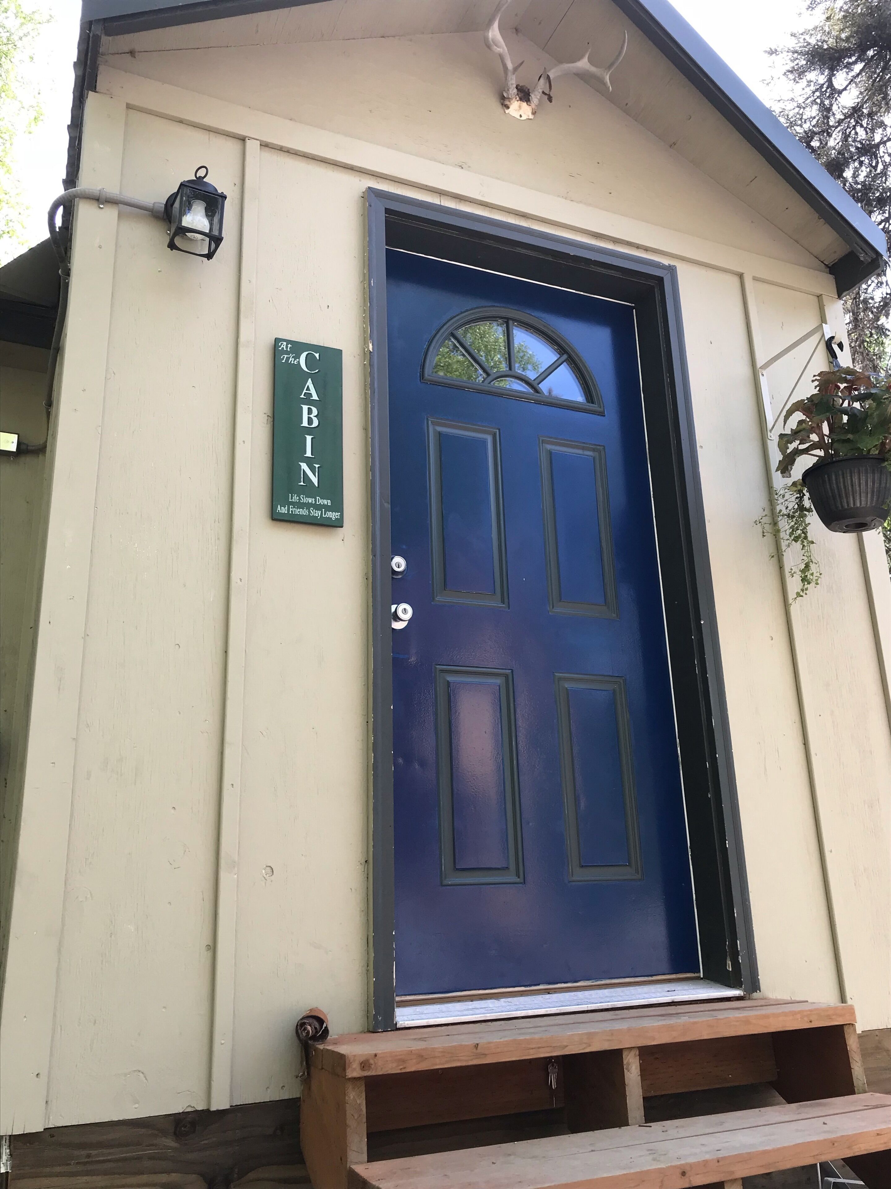 A blue door with a sign above it that reads "CABIN."