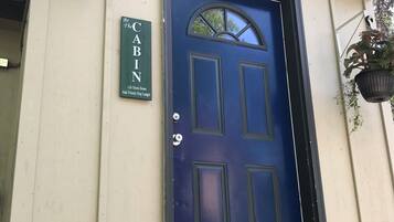 A blue door with a sign above it that reads "CABIN."