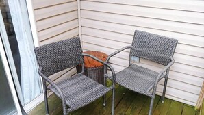 En liten sittgrupp i ett hörn, med två fåtöljer i rotting och ett litet runt bord.