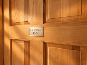 A wooden panel with a sign reading 'BEAR MOUNTAIN ROOM'.