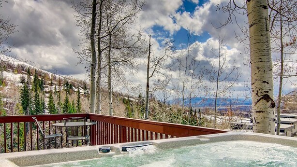 A hot tub on a deck with a view of mountains and trees. - Best Location - True Hike In/Out TH w/Private HotTub and Slope Views-Gas Fireplace-W/D in Unit (Steamboat Springs)