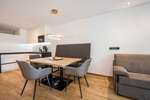 A modern kitchen with a dining table, chairs, and a sofa. - Modern Apartment "Nice 2" with Balcony in the Center of Bressanone/Brixen (Brixen)