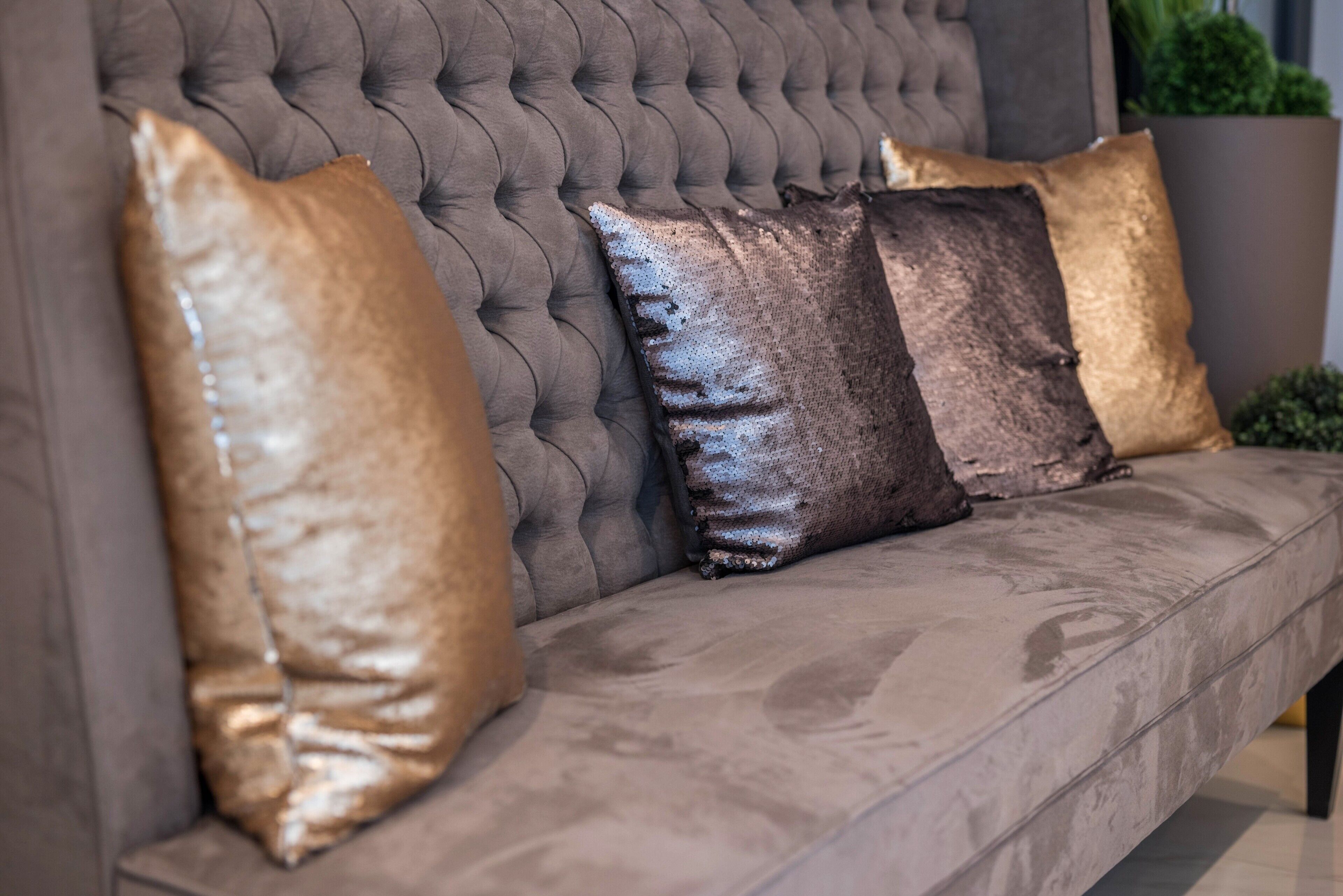 A tufted sofa with three cushions.
